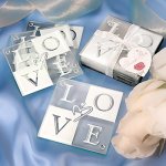 Set of four glass coasters with the word "LOVE".