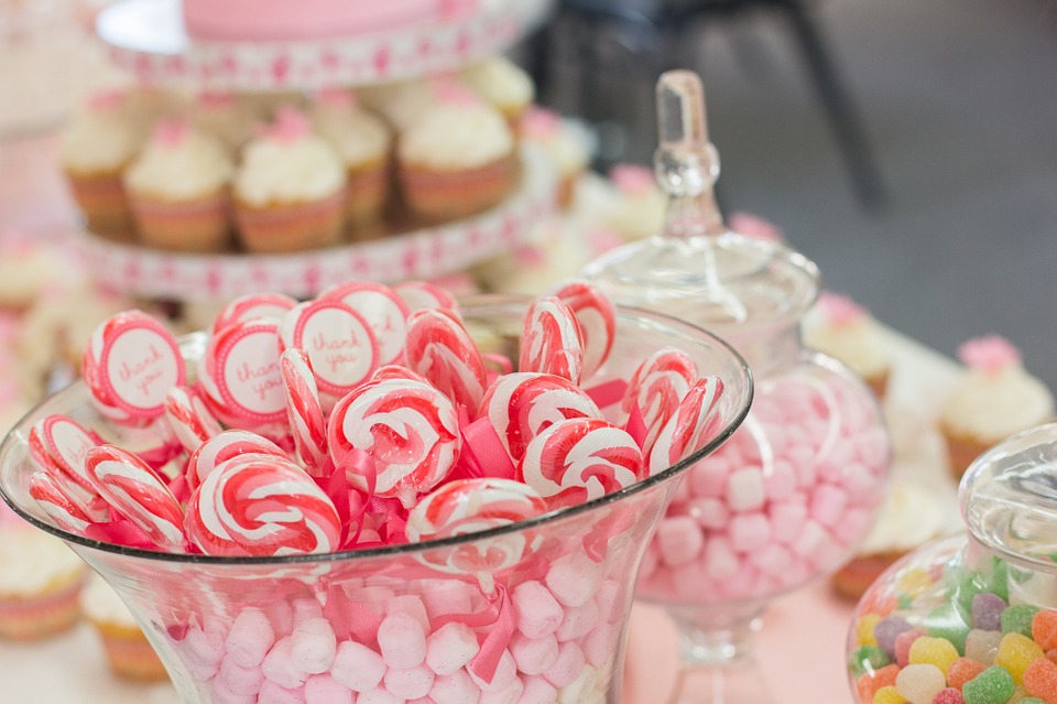 A bridal shower candy buffet can be enhanced with containers of different heights, and candy in your event colors.