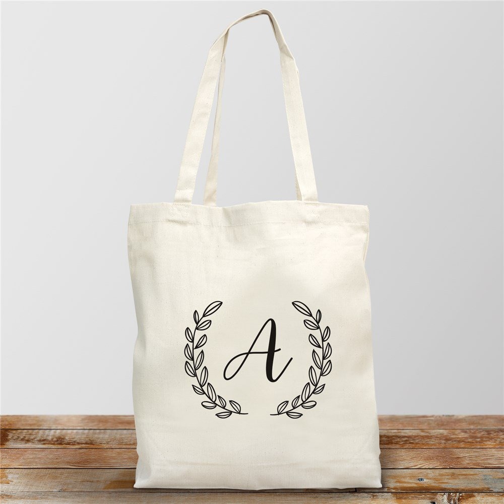 This personalized initial cotton tote can be given to the bride to be as is, or filled with something she likes. It has a leafy crown design and measures 16